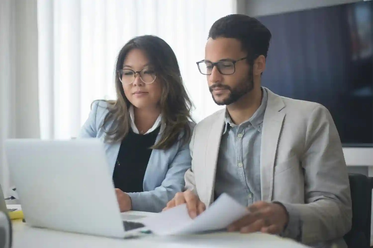 Advisor And Client Looking At Laptop