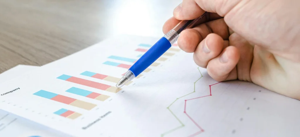 Employee Pointing To Bar Charts